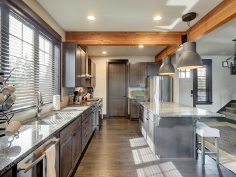Modern and rustic scandinavian kitchen interior with dark brown hardwood with wooden large beans.
